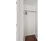 White closet with hanging rod and wood-look flooring at 1315 Old Coach Sw Rd, Marietta, GA 30008
