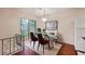 Dining room with a glass dining table, modern chairs, and a sliding glass door at 1315 Old Coach Sw Rd, Marietta, GA 30008