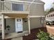 Townhome exterior featuring light green siding, a balcony, and a white front door with the address number at 1315 Old Coach Sw Rd, Marietta, GA 30008