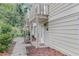 View of the side of the home with a balcony and landscaping at 1315 Old Coach Sw Rd, Marietta, GA 30008