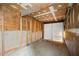 Unfinished garage with concrete floor and white door at 1315 Old Coach Sw Rd, Marietta, GA 30008