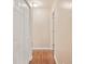 Hallway with hardwood floors and white doors leading to different rooms at 1315 Old Coach Sw Rd, Marietta, GA 30008