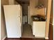 Bright kitchen with white appliances, cabinetry, double sink, and views of the dining and living areas at 1315 Old Coach Sw Rd, Marietta, GA 30008