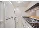 Kitchen with white appliances, countertop, and tile flooring providing ample counter space for cooking at 1315 Old Coach Sw Rd, Marietta, GA 30008