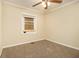 Neutral bedroom featuring plush carpet, one window, and ceiling fan at 1907 Oak Valley Rd, Decatur, GA 30035