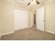 Neutral bedroom showing plush carpet, large closet, and ceiling fan at 1907 Oak Valley Rd, Decatur, GA 30035