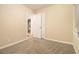 Neutral bedroom showcases plush carpet, large window, and closet at 1907 Oak Valley Rd, Decatur, GA 30035