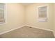 Cozy bedroom featuring neutral carpet, trim, and windows at 1907 Oak Valley Rd, Decatur, GA 30035