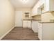 Well-lit kitchen featuring granite countertops, white cabinets, and hardwood floors at 1907 Oak Valley Rd, Decatur, GA 30035