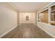 Bright living room with wood-look flooring and trim, open to adjacent dining area at 1907 Oak Valley Rd, Decatur, GA 30035