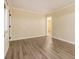 Neutral living room with wood-look flooring, simple trim, and adjacent room at 1907 Oak Valley Rd, Decatur, GA 30035