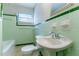 Bathroom features green tile, ceramic tile floors and pedestal sink at 1956 Joseph Ct, Decatur, GA 30032