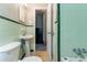 Bathroom with green tile, ceramic tile floors, pedestal sink and toilet at 1956 Joseph Ct, Decatur, GA 30032