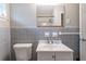 Bathroom features a toilet, sink, and mirror with accent lighting at 1956 Joseph Ct, Decatur, GA 30032