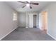 Bedroom with neutral paint, gray carpet, ceiling fan, closet, and natural light from windows at 1956 Joseph Ct, Decatur, GA 30032