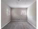 Bedroom with two windows, gray walls, neutral carpet and a ceiling light fixture at 1956 Joseph Ct, Decatur, GA 30032
