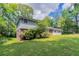 Two-story home with a lush green lawn, mature trees, and partial brick exterior, offering classic curb appeal at 1956 Joseph Ct, Decatur, GA 30032