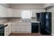 Classic kitchen with white cabinetry, black appliances, laminate countertops, and ample counter space at 1956 Joseph Ct, Decatur, GA 30032