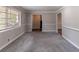 Comfortable living room with gray walls, new carpeting, large window, and decorative trim at 1956 Joseph Ct, Decatur, GA 30032