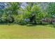 Large, grassy yard partially obscured by large trees in front of house at 1956 Joseph Ct, Decatur, GA 30032