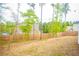 Large backyard with a wood fence and mature trees around the property at 284 Bryson Lake Cir, Douglasville, GA 30134
