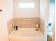 Bright bathroom with tiled bathtub and ample natural light at 284 Bryson Lake Cir, Douglasville, GA 30134
