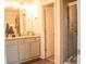 Bathroom featuring double sinks, granite countertops, and tiled shower at 284 Bryson Lake Cir, Douglasville, GA 30134