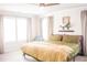 Bright bedroom featuring large windows, neutral carpet and comfortable queen bed at 284 Bryson Lake Cir, Douglasville, GA 30134