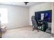 Bright bedroom with a gaming setup including a computer and large monitor on a desk with a comfortable gaming chair at 284 Bryson Lake Cir, Douglasville, GA 30134