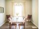Elegant dining room with wood floors, a stylish light fixture, seating for six, and modern decor at 284 Bryson Lake Cir, Douglasville, GA 30134