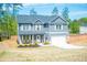 Two-story home with gray siding, white trim, an attached garage and well-manicured lawn in a suburban setting at 284 Bryson Lake Cir, Douglasville, GA 30134