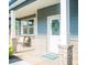 Charming front porch with gray siding, brick columns, a bench and a welcoming 'Hello' mat at the front door at 284 Bryson Lake Cir, Douglasville, GA 30134
