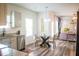 Bright and airy kitchen with stainless steel appliances, granite counters, and a glass dining table in an open-concept layout at 284 Bryson Lake Cir, Douglasville, GA 30134
