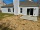 Home's backyard features a concrete patio, vinyl siding and sliding glass doors at 4192 Medlock River Ct, Snellville, GA 30039