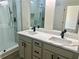 Bathroom featuring double sinks with quartz countertops and matte black hardware at 4192 Medlock River Ct, Snellville, GA 30039