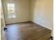 Bedroom featuring LVP flooring and window at 4192 Medlock River Ct, Snellville, GA 30039