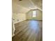 Spacious bonus room with wood-look floors, vaulted ceilings and a window at 4192 Medlock River Ct, Snellville, GA 30039