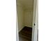 Small closet with wood-look flooring and simple wire shelving; ready for storage at 4192 Medlock River Ct, Snellville, GA 30039