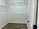 Walk-in closet with wood-look flooring and metal shelving, ready for organization at 4192 Medlock River Ct, Snellville, GA 30039