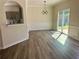 Dining room featuring modern light fixture, chair rail, new hardwood floors and sliding glass door at 4192 Medlock River Ct, Snellville, GA 30039