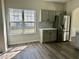 Charming kitchen with stainless steel refrigerator and gray cabinets at 4192 Medlock River Ct, Snellville, GA 30039