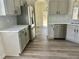 Bright kitchen with stainless steel appliances, gray cabinets and white countertops at 4192 Medlock River Ct, Snellville, GA 30039