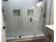 Modern bathroom with a tiled shower featuring dual shower heads and built-in niches at 4192 Medlock River Ct, Snellville, GA 30039