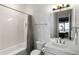 Bathroom featuring tub with subway tile surround, a shower curtain, and a vanity with lots of storage at 1720 Barclay Close Nw, Atlanta, GA 30318