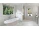 Elegant bathroom featuring a soaking tub, glass shower, and natural light at 1720 Barclay Close Nw, Atlanta, GA 30318