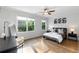 Sun-lit bedroom features a ceiling fan, and hardwood floors at 1720 Barclay Close Nw, Atlanta, GA 30318
