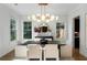 Dining room with statement lighting, neutral walls, hardwood floors, and a view of a modern, decorative mirror at 1720 Barclay Close Nw, Atlanta, GA 30318
