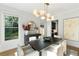 Bright dining room with modern light fixture, neutral walls, hardwood floors, and lots of light from large windows at 1720 Barclay Close Nw, Atlanta, GA 30318