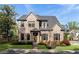 Charming two-story brick home featuring mature landscaping, a well-manicured lawn, and a welcoming front entrance at 1720 Barclay Close Nw, Atlanta, GA 30318