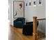 Stylish hallway featuring hardwood floors, modern art, and comfortable seating at 1720 Barclay Close Nw, Atlanta, GA 30318